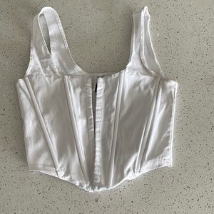 This is a white corset shirt. Sold by “JNK”